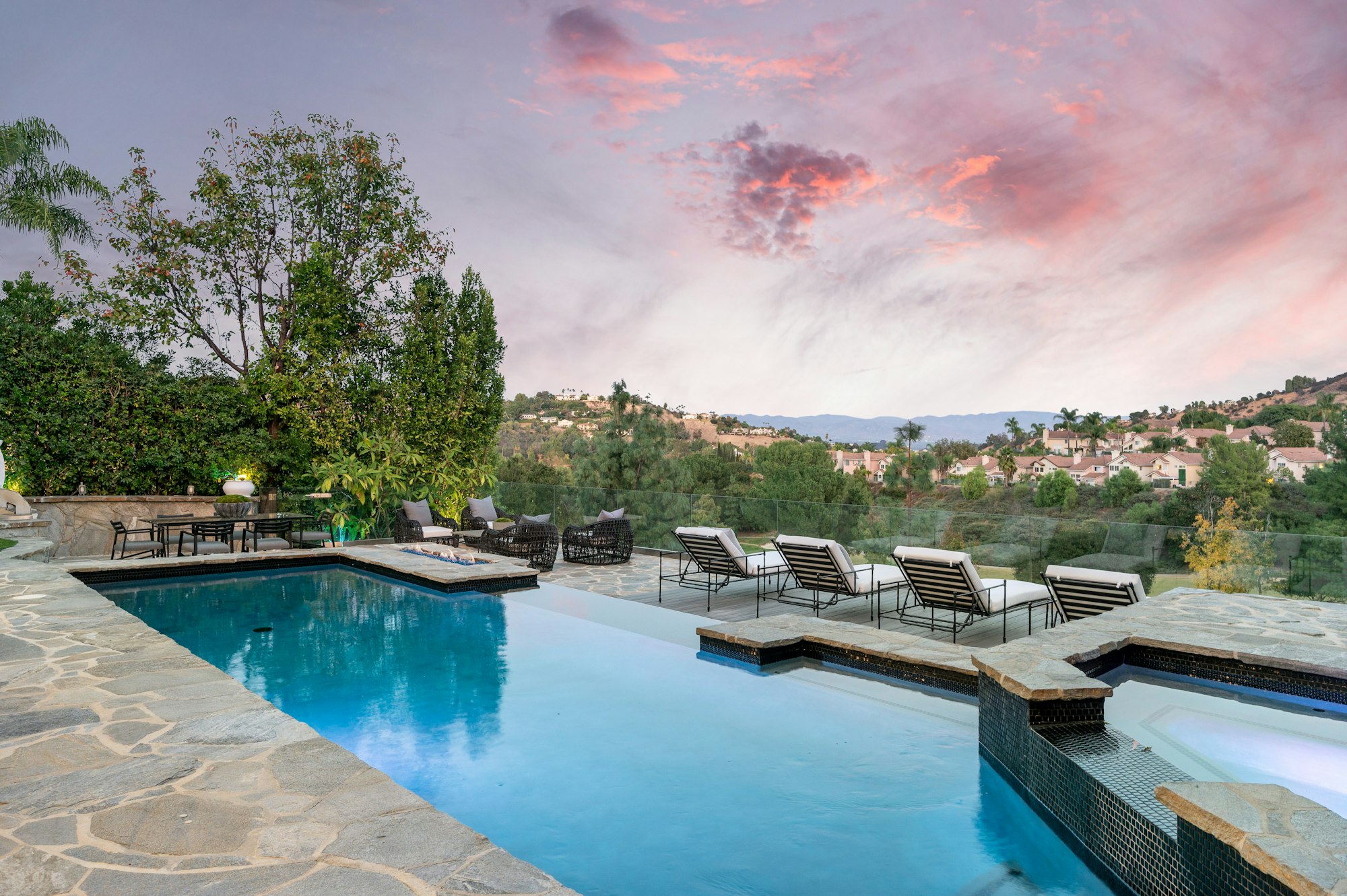 Swimming pool on a patio with a stunning sky backdrop